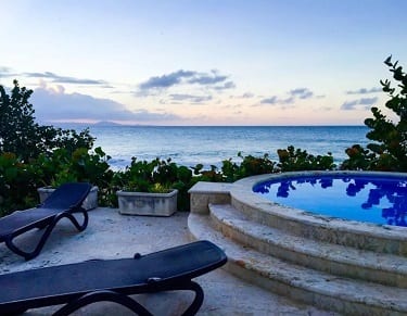 Image of Hispaniola Beach Oceanfront Residences hot tub in the evening