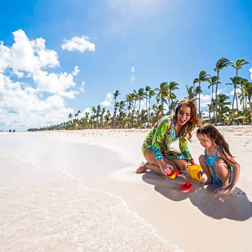 A mother and daughter playing in the sand in the Dominican Republic
