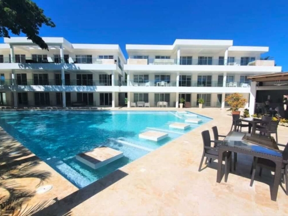 BeachWalk Boutique Hotel at Perla Marina condo exterior with pool area