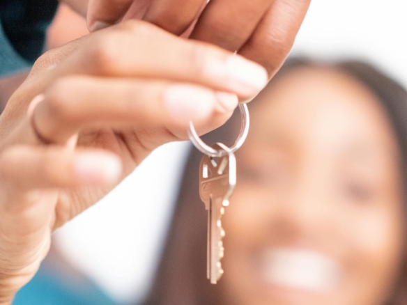 Happy people holding a property key invest in the Dominican Republic